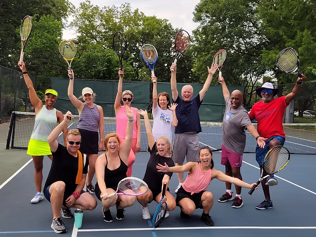 Adults playing tennis