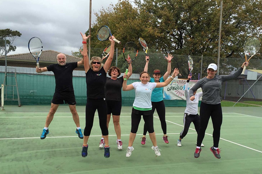 Adults playing tennis